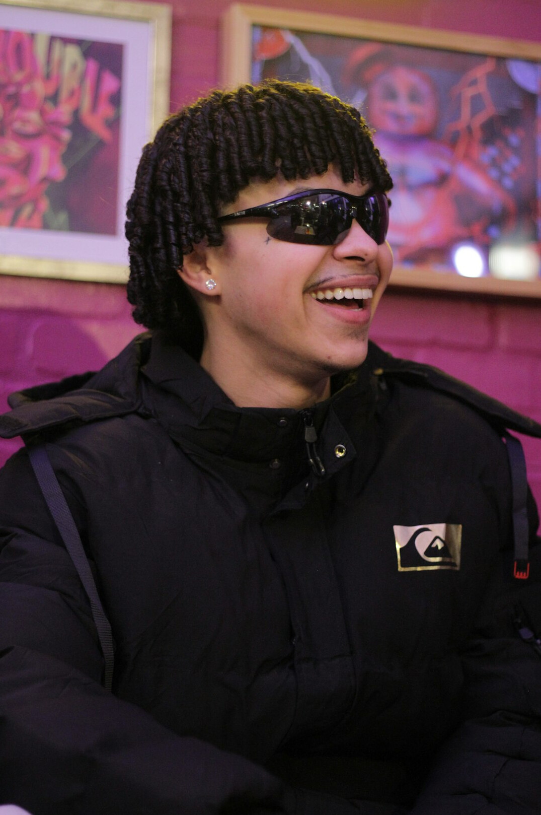 Portrait of a smiling man with short dark hair and glasses