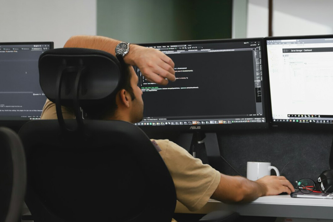 man coding at desk