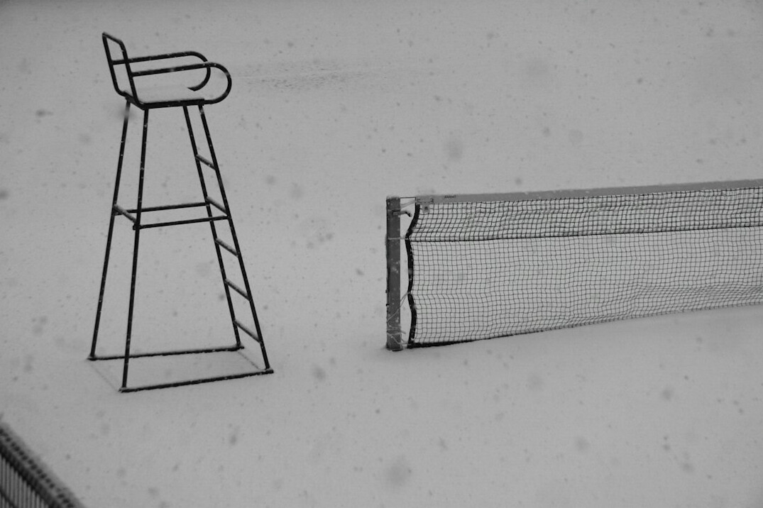 UX wireframe sketches on paper next to a tablet